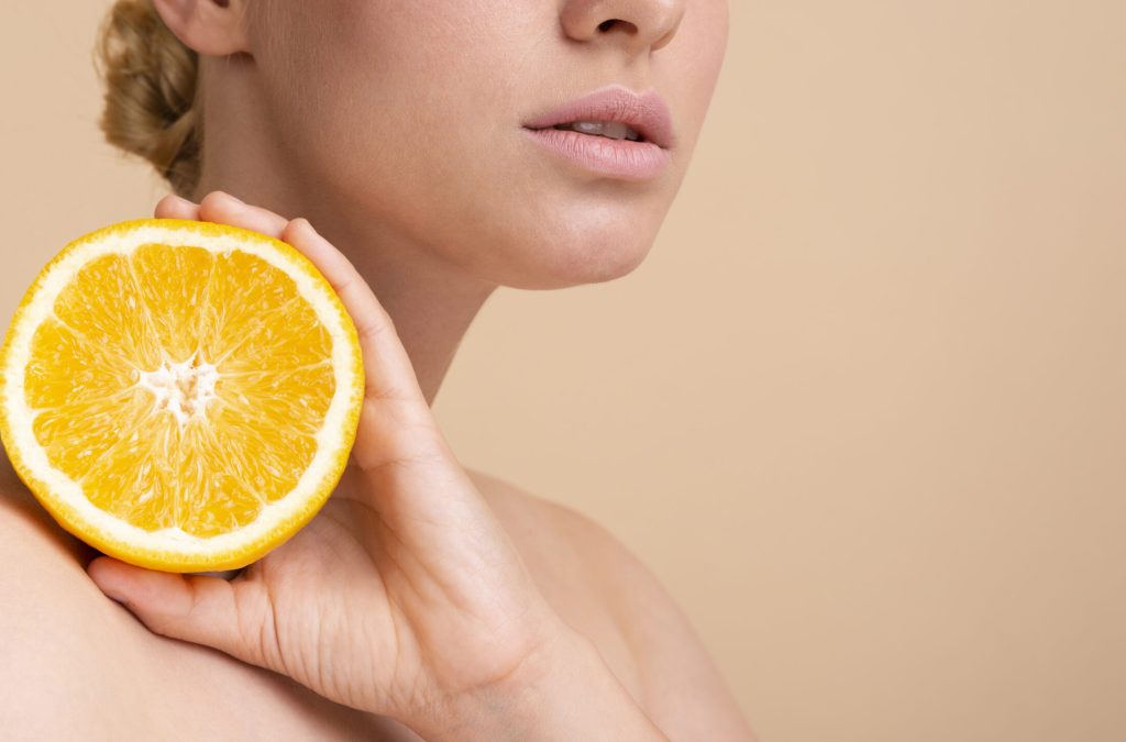 close-up-blonde-model-posing-with-orange